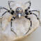 Handmade black and silver beaded spider ornament with iridescent accents and detailed wire legs, crafted by Beneath the Oak Designs.